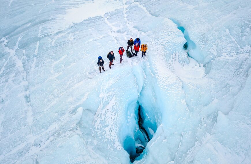 Drone photograph of people near a moulin on the Greenland Ice Sheet near Kangerlussuaq